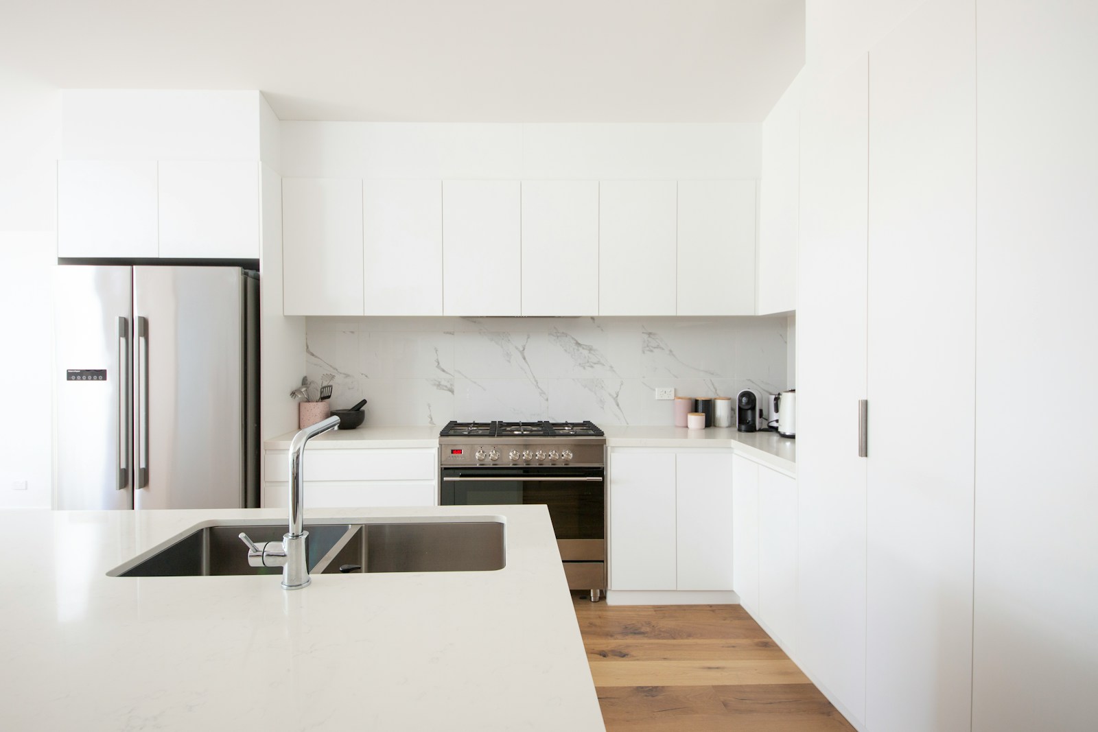 Modern white kitchen with light quartz countertops