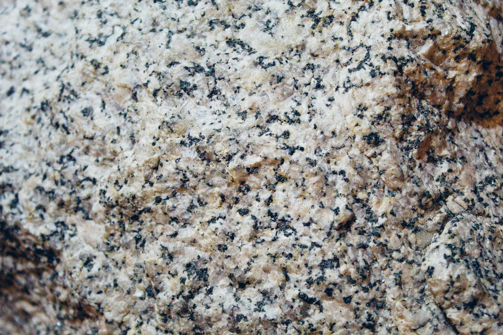 Close-up of brown and black granite countertop slab texture