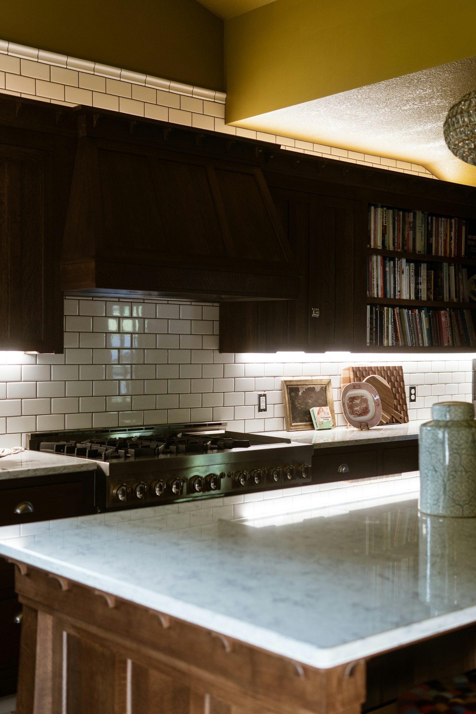 A kitchen counter next to a stovetop and sink, ready for everyday use.