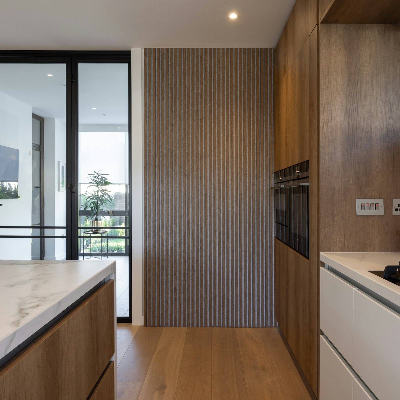 Warm kitchen with wooden cabinets and a light stone countertop.